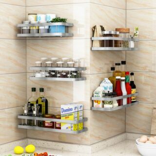 Plusieurs étagères murales d’angles pour épices de cuisine fixées sur un mur en carrelage